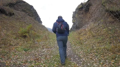 Hiker with backpack going up the hill Stock Footage 80898953