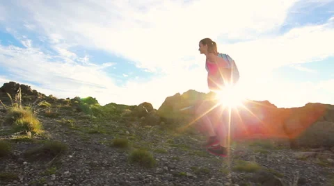 Hiker with Backpack Hiking on top of a mountain with sun flares. Young Woman  스톡 동영상 57135055