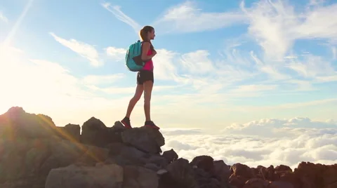 Hiker with Backpack Hiking on top of a mountain with sun flares. Young Woman  Stockbeeldmateriaal 57135165