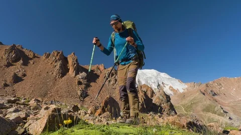 Hiker with a backpack makes a trip in the mountains Stock Footage 113822872