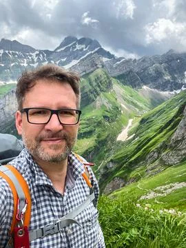 Hiker with Backpack in the Mountains Stock Photos