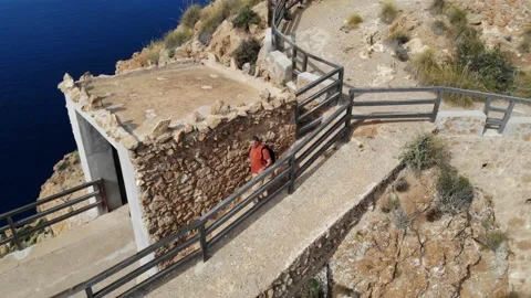 The hiker with a backpack reaches the viewpoint at Cabo Tinoso. Stock Footage 138207958