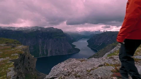 Hiker with backpack reaching lookout point and enjoying the view, standing on Stock Footage 99707353