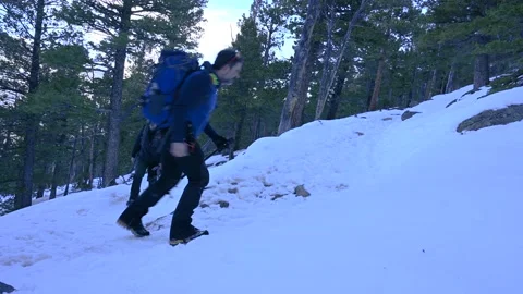 Hiker with backpack on snowy trail Stock Footage 151058088