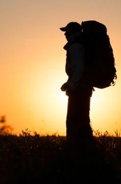 Hiker with backpack standing in the field Stock Photos