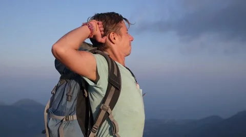 Hiker with Backpack Standing on Top of Mountain with Raised Hands 動画素材 63507907