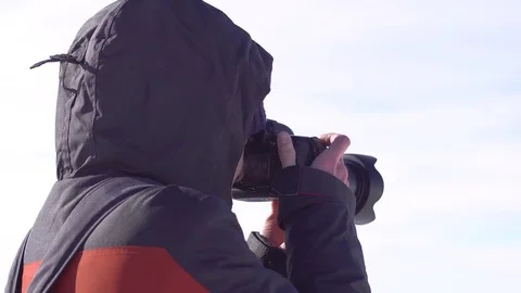 Hiker with backpack standing on top of a mountain and enjoying Stock Footage 73753551