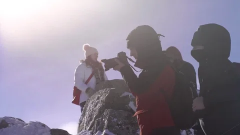 Hiker with backpack standing on top of a mountain and enjoying Stock Footage 73753600