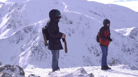 Hiker with backpack standing on top of a mountain and enjoying Stock Footage 73753719