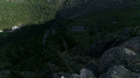 Hiker with backpack standing on top of a mountain with raised hands and enjoying Stock Footage 77874352