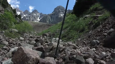 Hiker with backpack walking along a mountain trail Stock Footage 67813709