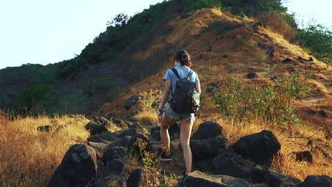 Hiker with backpack walking in mountain Stock Footage