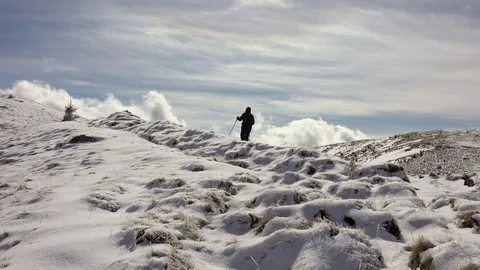 Hiker With Backpack Walking On A Mountain Ridge, Covered With Deep Snow Stock Footage 126116427