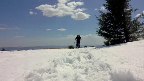 Hiker With Backpack Walking On A Mountain Ridge, Covered With Deep Snow Stock Footage 152614744