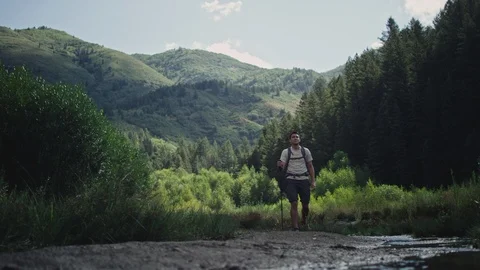Hiker with Backpack walks in mountains Stock Footage 127061312