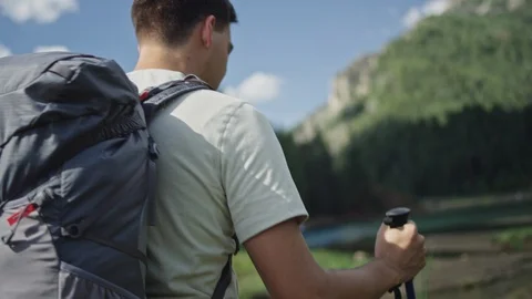 Hiker with Backpack walks in mountains Stock Footage 127461055