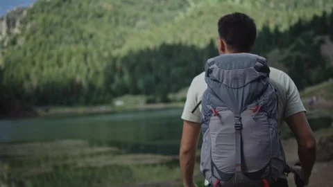 Hiker with Backpack walks in mountains Stock Footage 127461139