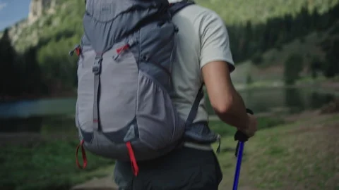 Hiker with Backpack walks in mountains Stock Footage 127461178