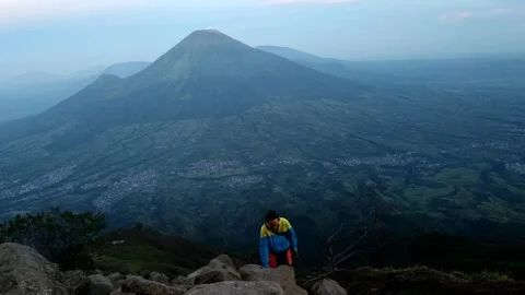 A hiker with beautiful mountain and cloud views Stock Footage 263909401