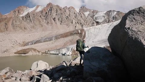 Hiker with big backpack in the mountains Stock Footage 243877174