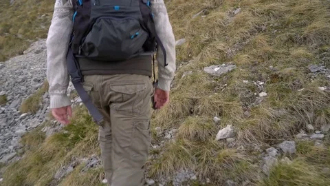 Hiker climbing the mountain slopes Stock Footage 75924435