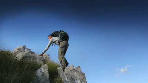 Hiker climbing rocks to look at view Stock Footage 45500334