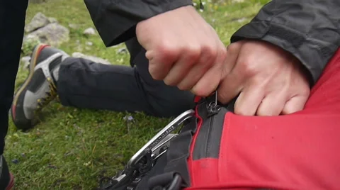 Hiker closing zip on his backpack Stock Footage 43248966