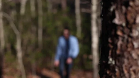 Hiker coming up trail from behind trees Stock Footage 63886946