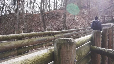 Hiker crossing the bridge side  Stock Footage 230586867