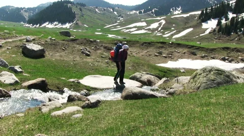 Hiker Crossing A Small River Stock Footage 57101788