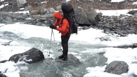 Hiker Crossing A Small River Video stock 91476302