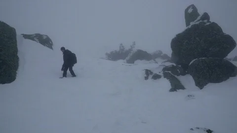 Hiker descends iced mountain Stock Footage 86664232