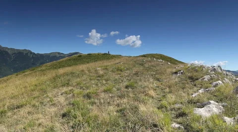 Hiker with dog on mountain path Stock Footage 45534564