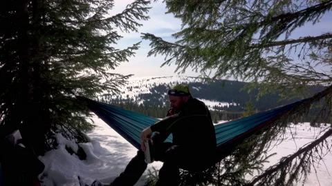 Hiker Drinking Cofee, Relaxing, Lying In Hammock In Winter Forest Stock-Footage 172111415