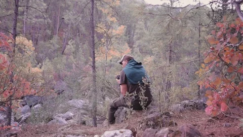 Hiker drinking coffee on the cliff face, hiking Stock Footage 200878384