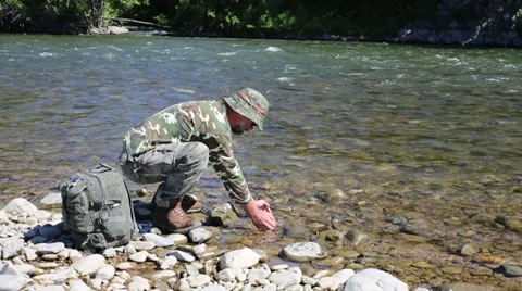Hiker drinking water from the river in the hands. 스톡 동영상 28738754