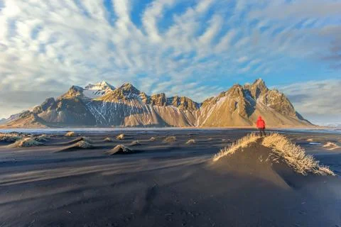 Hiker enjoying sunset at Vestrahorn and its black sand beach in Iceland Stock Photos