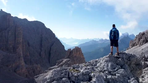 Hiker enjoying the view high up on a mountain Stock Footage 159398249
