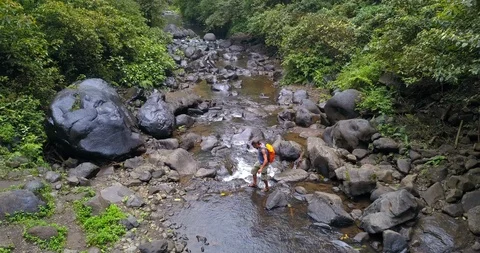 Hiker explore the Sekumpul Falls Stock Footage 96014644