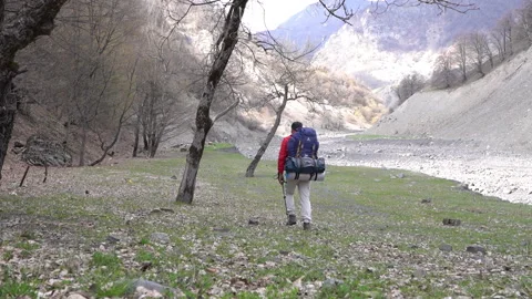 Hiker Exploring Forest Near River to Set Up Camp Video stock 303659373