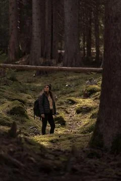Hiker exploring mossy forest path contemplating nature Stock Photos