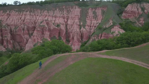 Hiker exploring the stunning red ravine of Rapa Rosie in Transylvania, Romania Stock Footage 337447614
