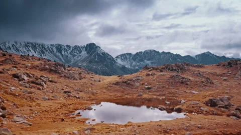 Hiker exploring the tranquil Pyrenees landscape in Spain under cloudy skies Stock Footage 303629062