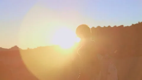 Hiker on a high mountain trail in the rays of the setting sun Stock Footage 146669522