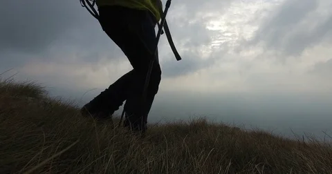 Hiker hiking on the edge of the mountain. Stock Footage 82467776