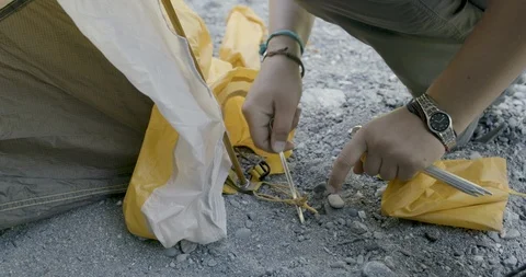 Hiker installing a tent Stock Footage 145277654