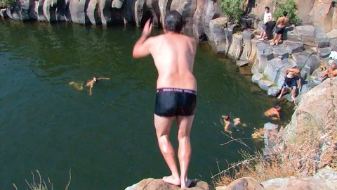 Hiker jumping in pool 05 Stock Footage 89480673