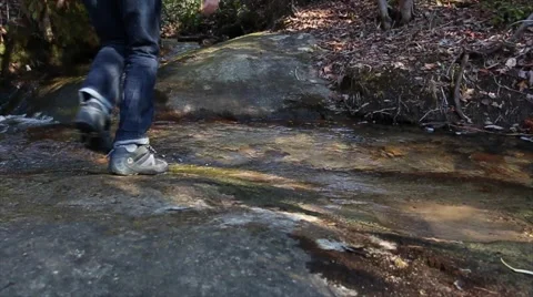 Hiker jumping small Creek Stock Footage 63887149