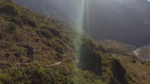 A hiker with a large hiking backpack and trekking poles 動画素材 259791636