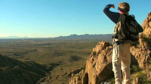 Hiker looking over edge of cliff - HD  스톡 동영상 361003